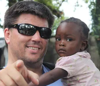 A man holding a child in his arms.