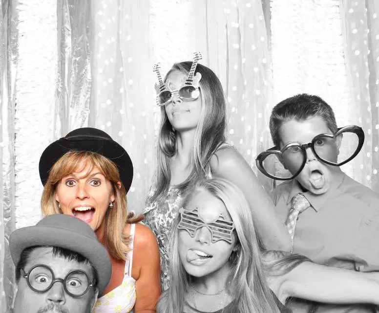 A group of people posing for a photo booth picture.