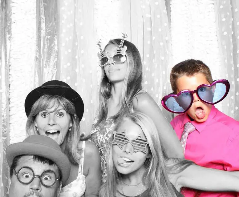 A group of people posing for a picture in a photo booth.