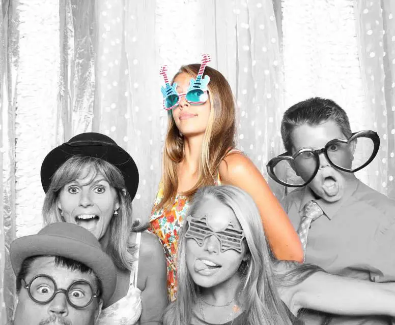 A group of people that are in the photo booth.